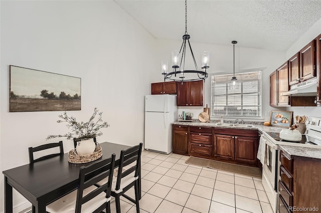 kitchen with white appliances, light tile patterned floors, vaulted ceiling, a textured ceiling, and under cabinet range hood