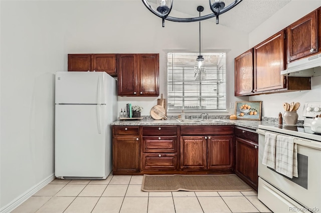 kitchen with light tile patterned floors, lofted ceiling, a sink, white appliances, and under cabinet range hood