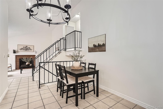 dining area with an inviting chandelier, baseboards, light tile patterned floors, and stairway