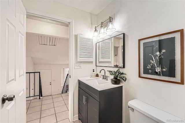 bathroom with tile patterned flooring, vanity, and toilet