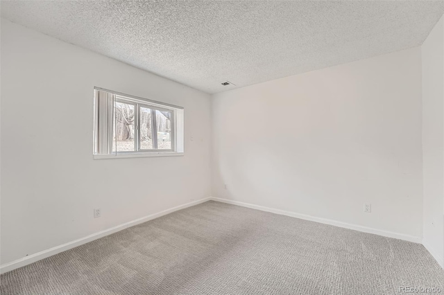 unfurnished room with carpet and baseboards