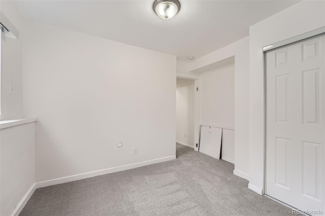 unfurnished bedroom with carpet flooring and baseboards