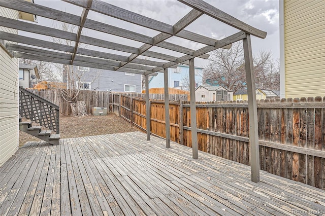 wooden terrace with a fenced backyard