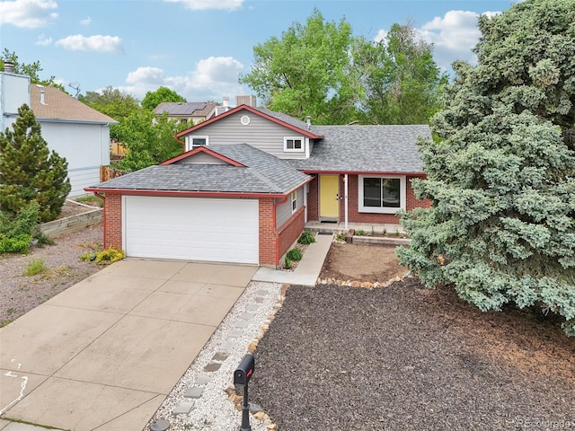 6337 W 68th Pl, Arvada, CO 80003 - view of front facade featuring roof with shingles, brick siding, an attached garage, and driveway