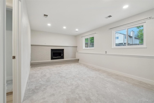 6337 W 68th Pl, Arvada, CO 80003 - unfurnished living room featuring carpet flooring, recessed lighting, baseboards, and a brick fireplace