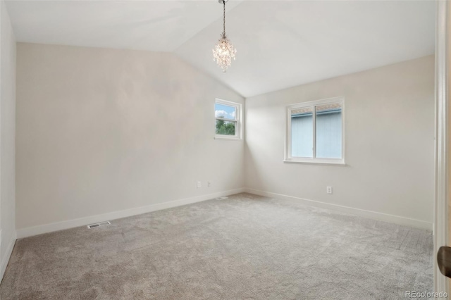 6337 W 68th Pl, Arvada, CO 80003 - spare room with a chandelier, baseboards, lofted ceiling, and carpet