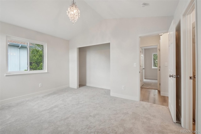 6337 W 68th Pl, Arvada, CO 80003 - unfurnished bedroom with vaulted ceiling, carpet floors, baseboards, and a chandelier