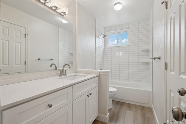 6337 W 68th Pl, Arvada, CO 80003 - full bath with wood finished floors, vanity, toilet, and shower / tub combination