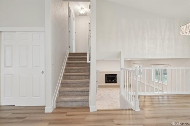 6337 W 68th Pl, Arvada, CO 80003 - stairway with wood finished floors, baseboards, and a fireplace with raised hearth