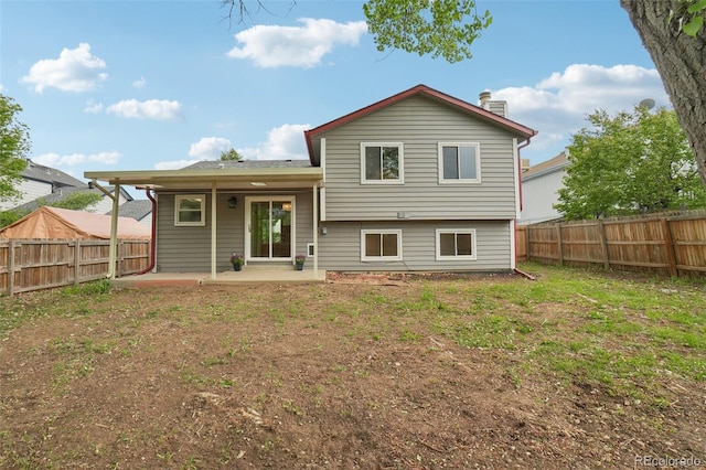 6337 W 68th Pl, Arvada, CO 80003 - back of property with a patio area, a fenced backyard, and a chimney