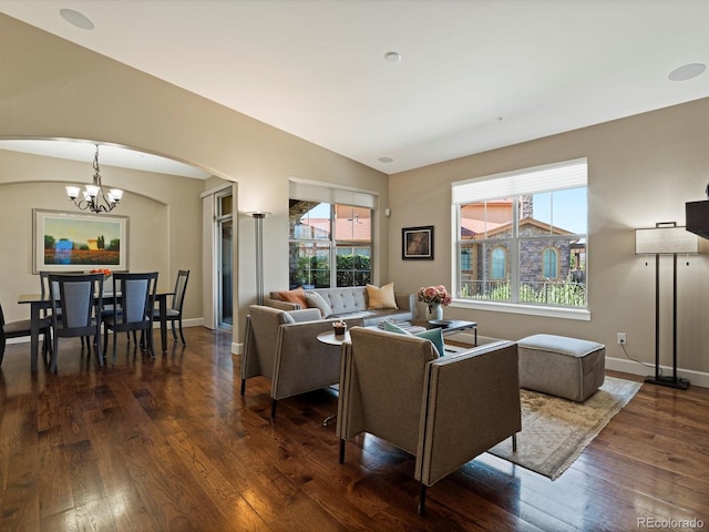 2363 Primo Rd Unit A, Highlands Ranch, CO 80129 - living area featuring arched walkways, dark wood finished floors, a chandelier, and vaulted ceiling