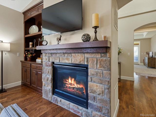 2363 Primo Rd Unit A, Highlands Ranch, CO 80129 - detailed view of arched walkways, wood finished floors, and a fireplace