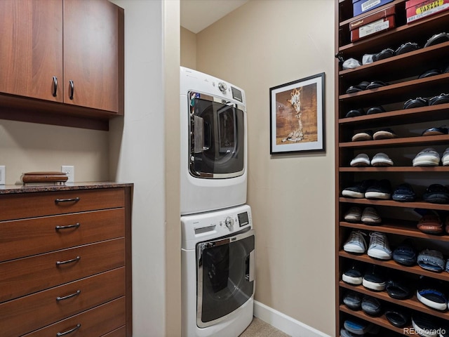 2363 Primo Rd Unit A, Highlands Ranch, CO 80129 - laundry room featuring stacked washer / drying machine and baseboards