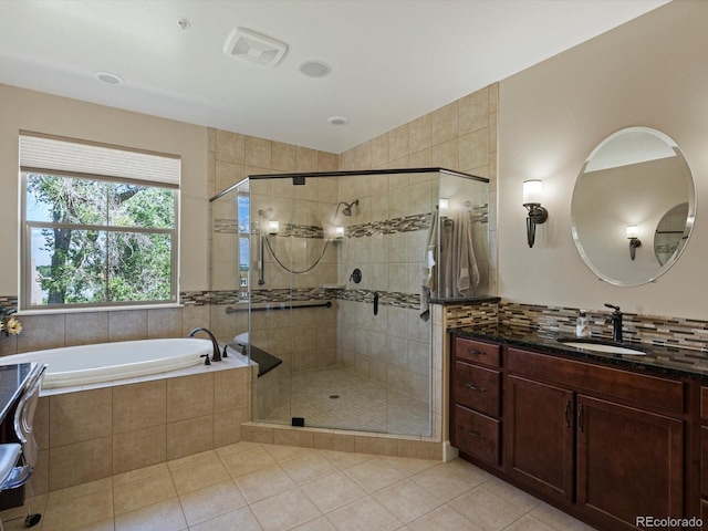 2363 Primo Rd Unit A, Highlands Ranch, CO 80129 - full bathroom featuring tile patterned floors, vanity, a bath, and a stall shower
