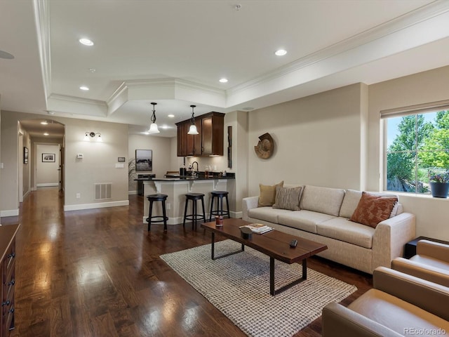 2363 Primo Rd Unit A, Highlands Ranch, CO 80129 - living room featuring a tray ceiling, crown molding, dark wood-style flooring, and recessed lighting