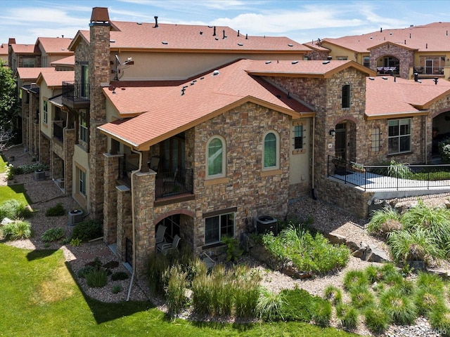 2363 Primo Rd Unit A, Highlands Ranch, CO 80129 - rear view of property featuring stone siding