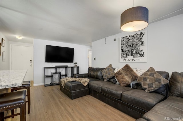 living room featuring light wood-style floors and baseboards