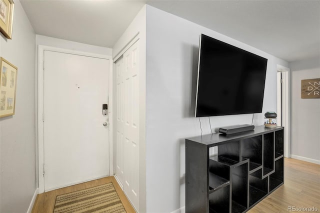 interior space featuring baseboards and light wood-type flooring