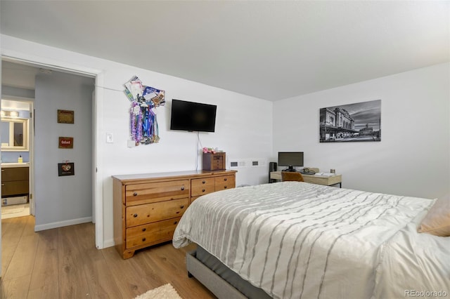 bedroom with light wood-type flooring and baseboards