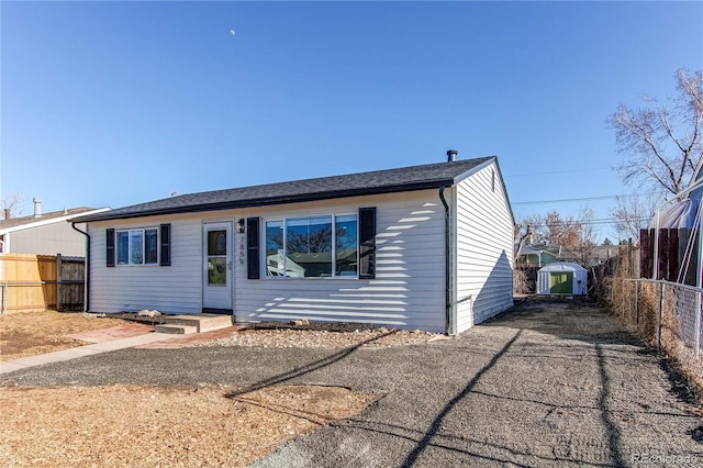 ranch-style home featuring a shed