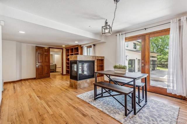 dining room with light hardwood / wood-style floors and a textured ceiling