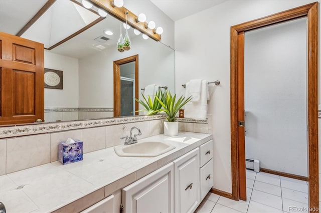 bathroom featuring tile patterned floors, vanity, and a baseboard heating unit