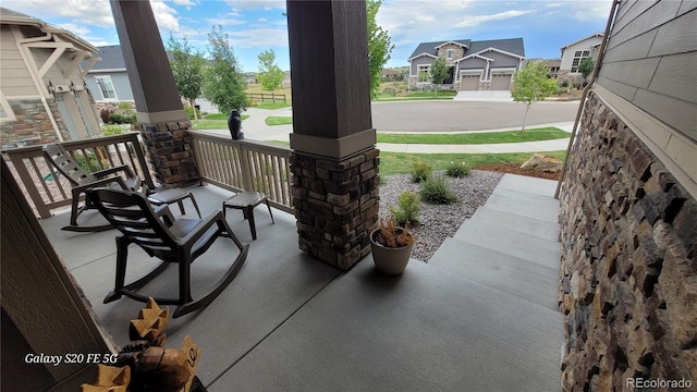 view of patio / terrace featuring a garage and covered porch