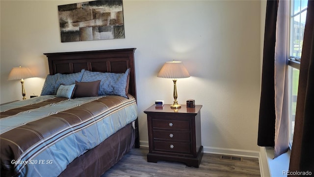 bedroom with wood-type flooring