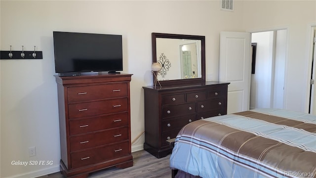 bedroom with hardwood / wood-style flooring