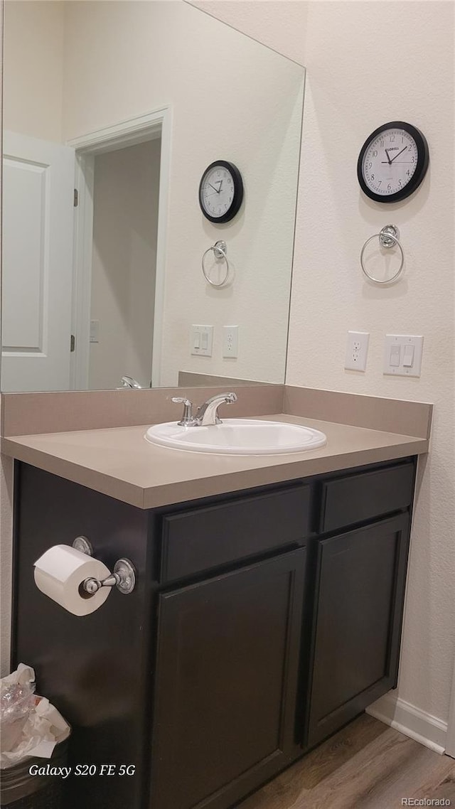 bathroom featuring hardwood / wood-style floors and vanity