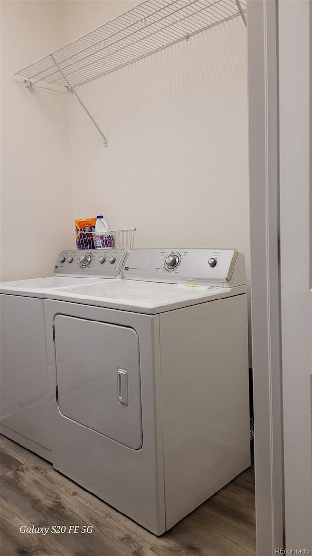 washroom featuring hardwood / wood-style floors and washer and dryer