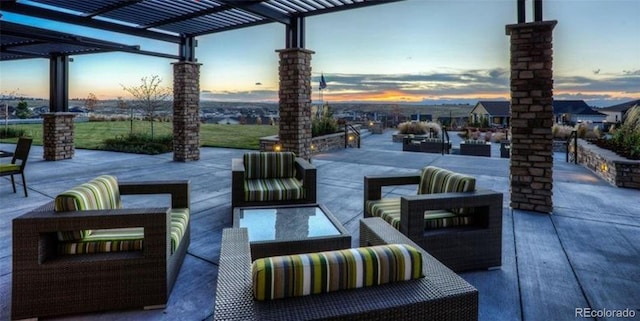 patio terrace at dusk featuring a pergola and an outdoor hangout area