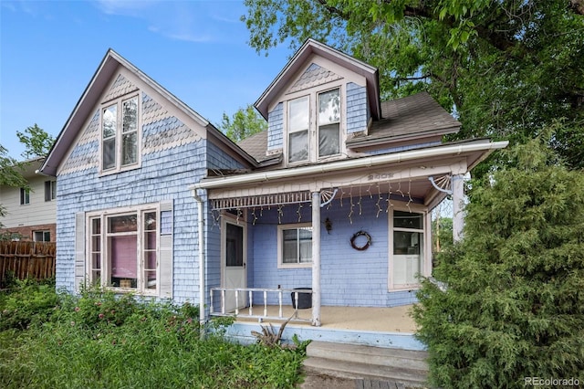 2402 W Uintah St, Colorado Springs, CO 80904 - victorian-style house featuring covered porch and a shingled roof