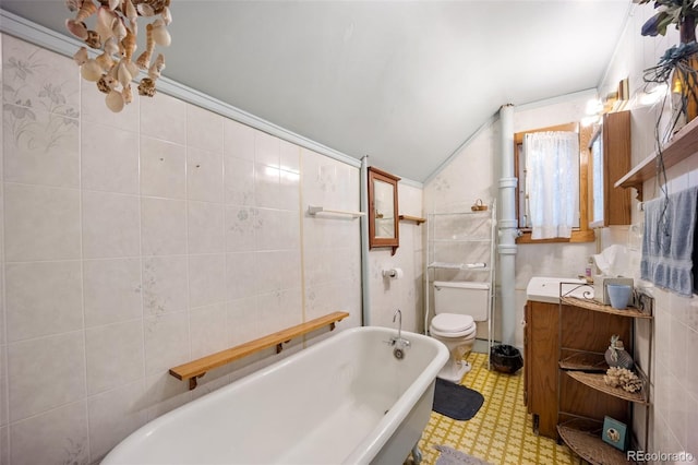 2402 W Uintah St, Colorado Springs, CO 80904 - full bathroom with a tub, vaulted ceiling, tile walls, tile patterned floors, and vanity