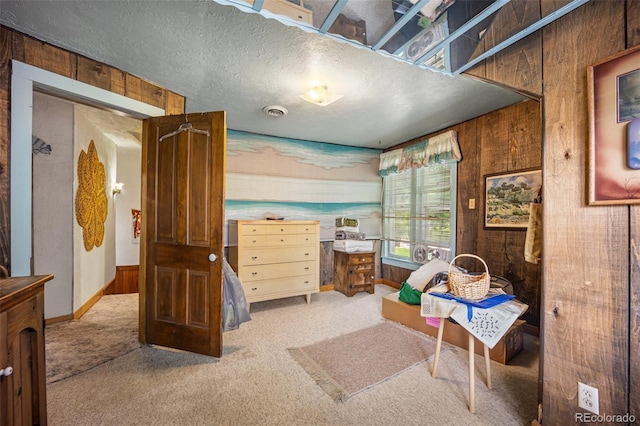2402 W Uintah St, Colorado Springs, CO 80904 - sitting room with wooden walls, carpet, and a textured ceiling