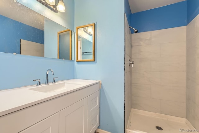 bathroom featuring vanity and tiled shower