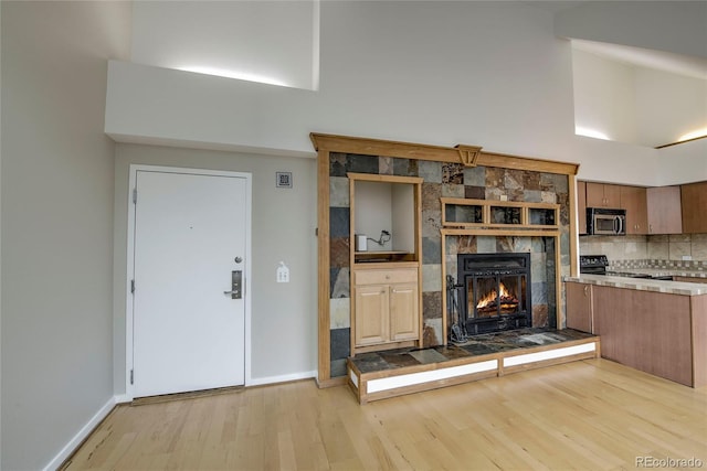 21650 US Highway 6 Unit 2096, Dillon, CO 80435 - living room featuring wood finished floors, a high ceiling, and a fireplace