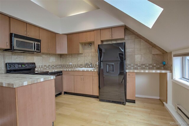 21650 US Highway 6 Unit 2096, Dillon, CO 80435 - kitchen featuring black appliances, a baseboard radiator, light wood-style flooring, a skylight, and vaulted ceiling