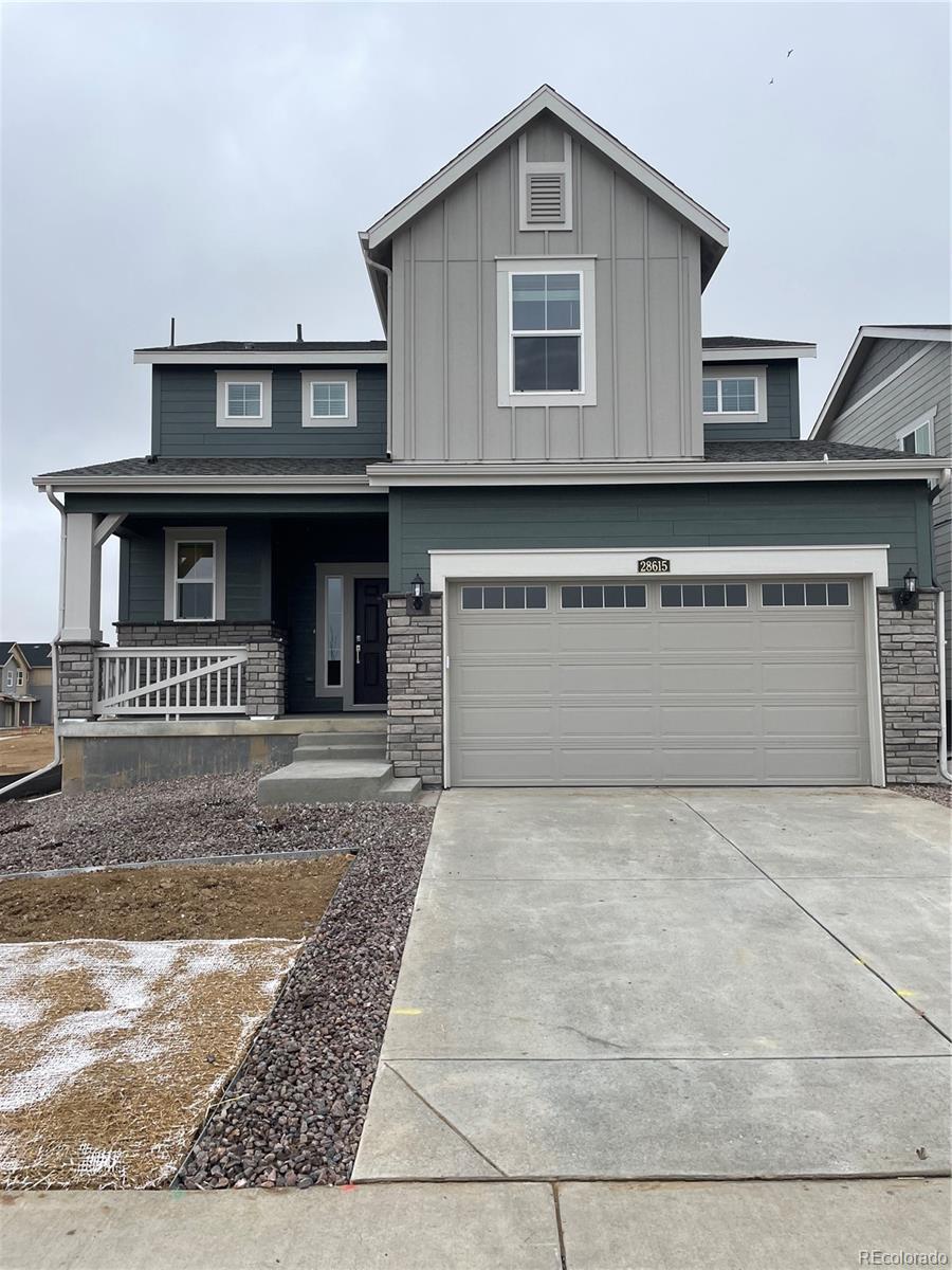 view of front of property featuring concrete driveway, covered porch, an attached garage, board and batten siding, and stone siding