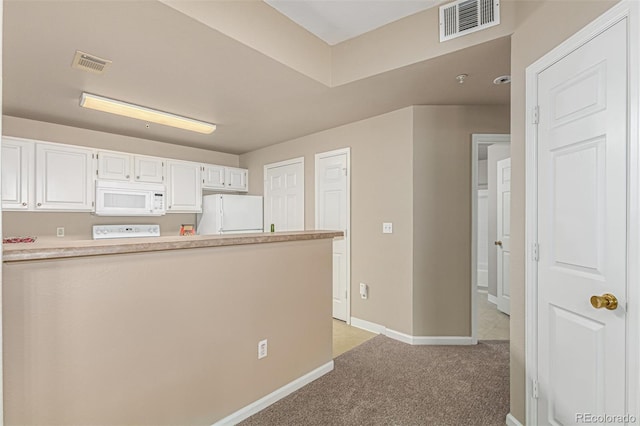 kitchen featuring visible vents, light colored carpet, white appliances, and white cabinets