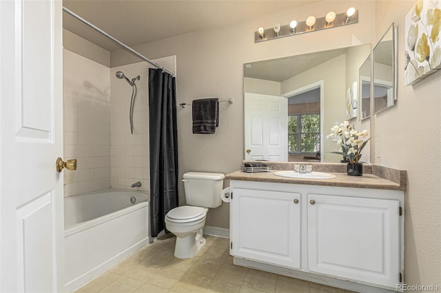 bathroom with baseboards, toilet, a textured wall, shower / bath combination with curtain, and vanity