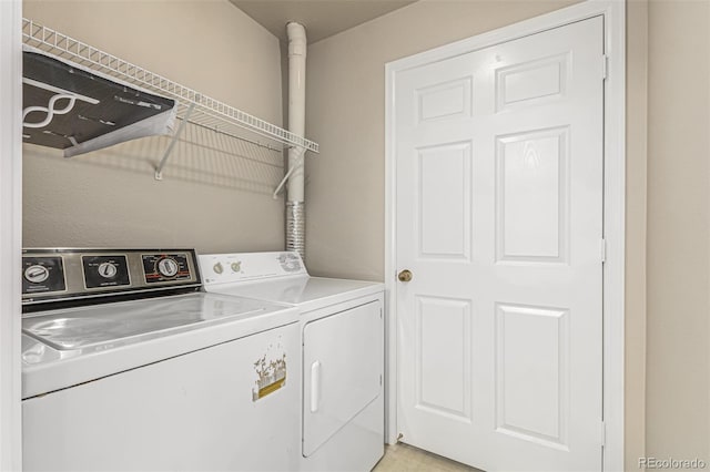 laundry room featuring separate washer and dryer and laundry area