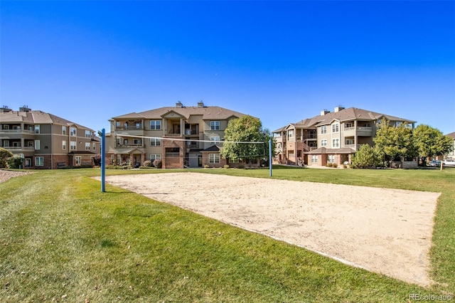 view of community with a yard, a residential view, and volleyball court