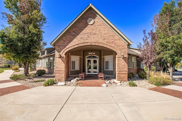 view of front facade featuring french doors and brick siding