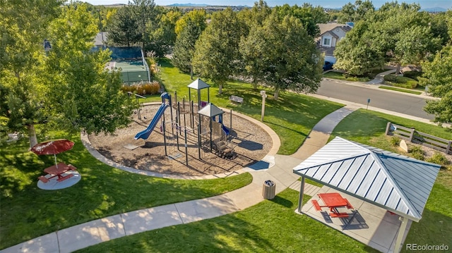 community jungle gym featuring a lawn