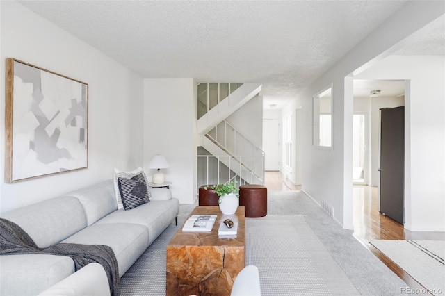 9453 W Utah Pl, Lakewood, CO 80232 - carpeted living area with stairway and a textured ceiling