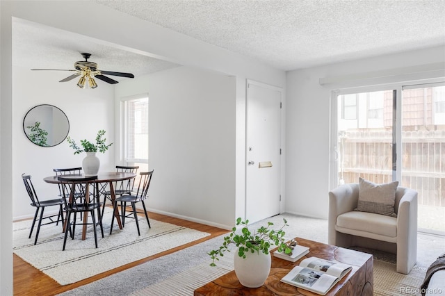 9453 W Utah Pl, Lakewood, CO 80232 - living room featuring a textured ceiling, ceiling fan, wood finished floors, and baseboards