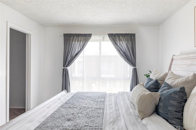 9453 W Utah Pl, Lakewood, CO 80232 - bedroom featuring a textured ceiling and carpet flooring