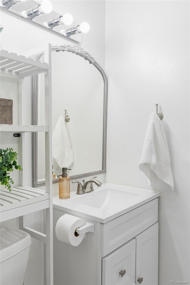 9453 W Utah Pl, Lakewood, CO 80232 - half bathroom featuring vanity and toilet
