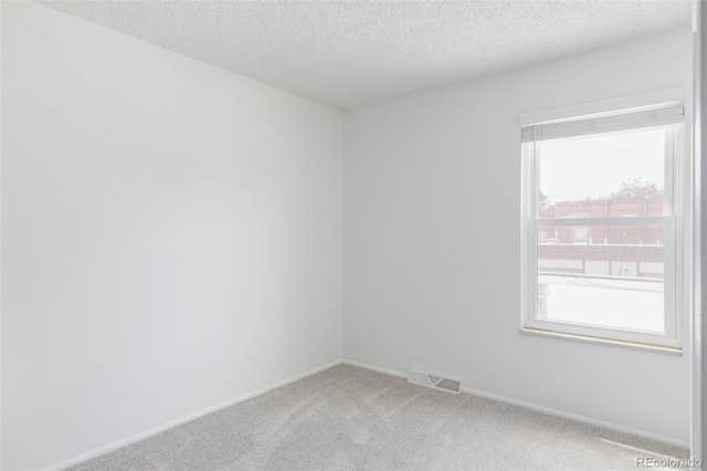 9453 W Utah Pl, Lakewood, CO 80232 - carpeted empty room with plenty of natural light, a textured ceiling, and baseboards